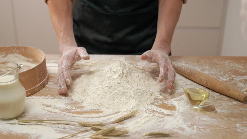 Cook Pours Out Flour In Hands