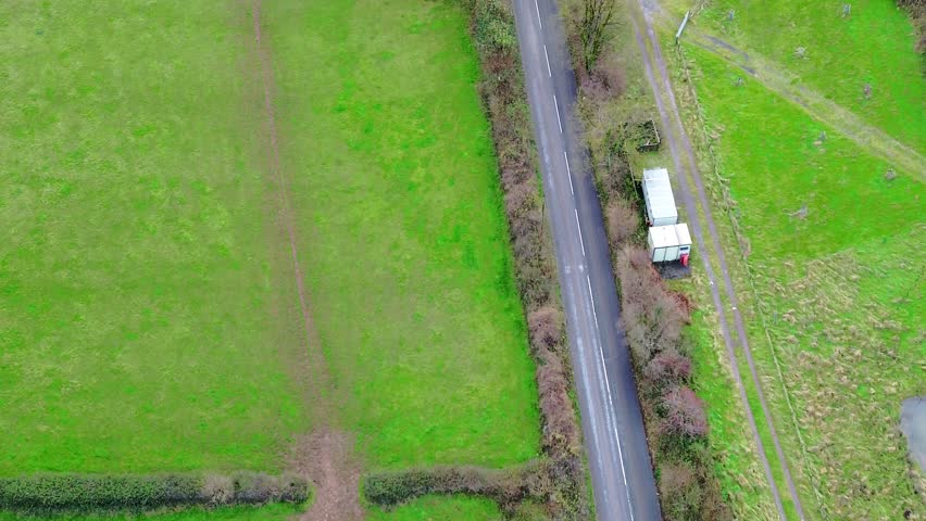 Cars driving down uk country roads