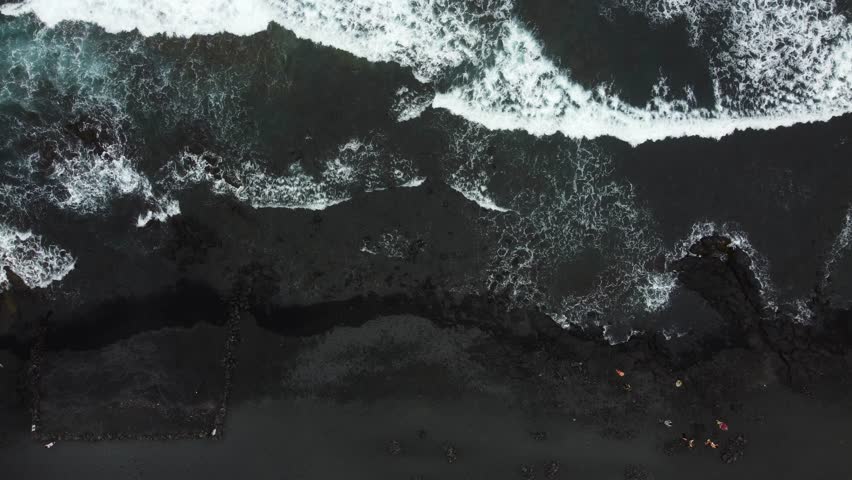 Overhead shot of black sand beach