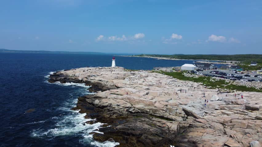 Aerial shot of lighthouse on large expanse of bedrock