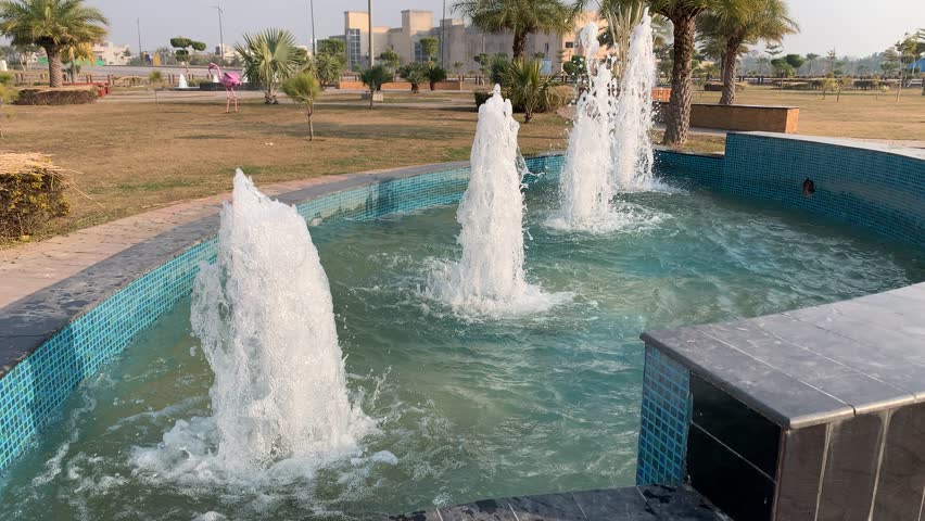 A close-up view of a splashing water fountain in the garden. Beautiful water fountain with many fountains in the park. 