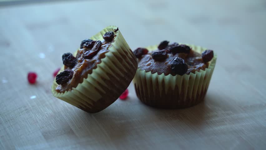 Two fresh baked muffins with cranberries falling on top out the oven vegan pumpkin muffins using real roasted pumpkin in bowl healthy dairy-free recipe vegan