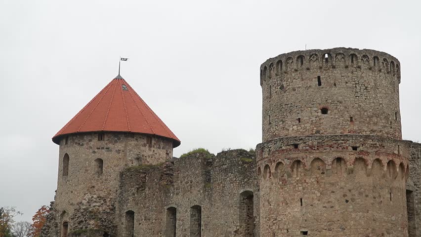 Medieval Castle Towers with Flag Under Cloudy Sky