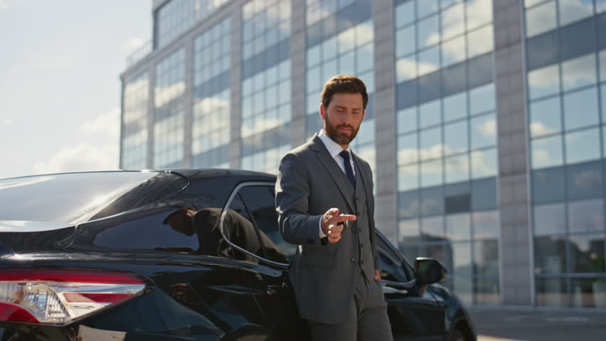 Luxury car owner smiling on business street after buying vehicle zoom in. Happy successful businessman playing with keys leaning on expensive automobile. Rich man satisfied auto purchase close up. Royalty-Free Stock Footage #3408977277