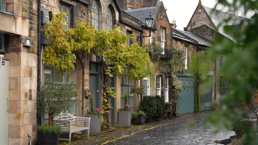 Famous cute narrow cobblestone street, with old cottages. Circus Lane, in Edinburgh