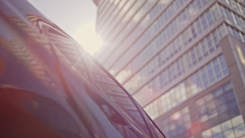 Businesswoman leaving luxury automobile walking to office work close up. Attractive elegant woman getting out expensive car on sunny street. Successful lady entrepreneur open door auto premium class.