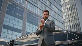 Rich businessman posing at car buttoning jacket zoom out. Elegant bearded man millionaire standing urban street near automobile premium class. Confident wealthy ceo relaxing outdoors feeling success. - Powered by Shutterstock - Get 15% off with code: PIKWIZARD15