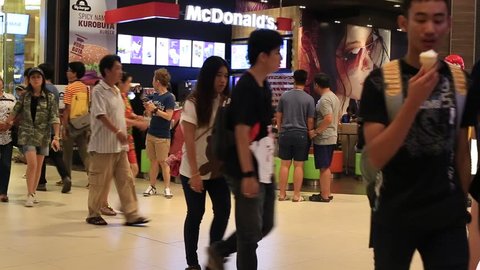 BANGKOK,THAILAND - FEBRUARY 13, 2016: Unidentified people walking near the McDonald's restaurant in Siam Paragon Mall. With 300,000 sqm of retail space Siam Paragon is one of the world's largest malls