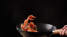 Chef cooking shrimps with oil on wok frying pan close-up. Prawns on fire throwing them on pan. Restaurant Food concept. Sea food. - Powered by Shutterstock - Get 15% off with code: PIKWIZARD15