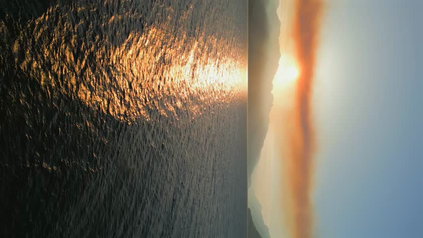Aerial landscape view of Harrison Lake and mountains at sunset.