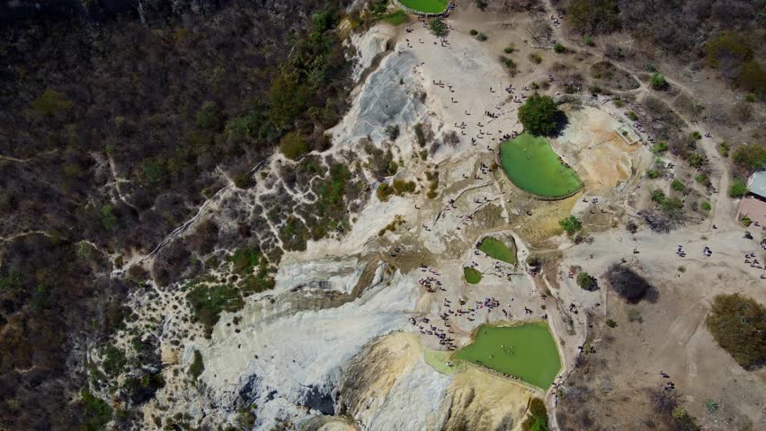 top of a white mountain with blue lakes and springs in Mexico hierve del agua oaxaca drone view