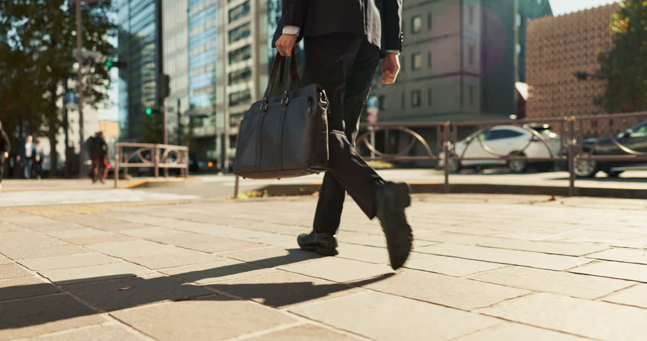 Legs, bag and business person walking, worker travel or commute to work in city with buildings. Corporate professional, sidewalk on urban street and journey to office with commuter in the morning Royalty-Free Stock Footage #3409143285