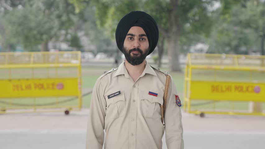 Happy Sikh Indian police man showing thumbs up