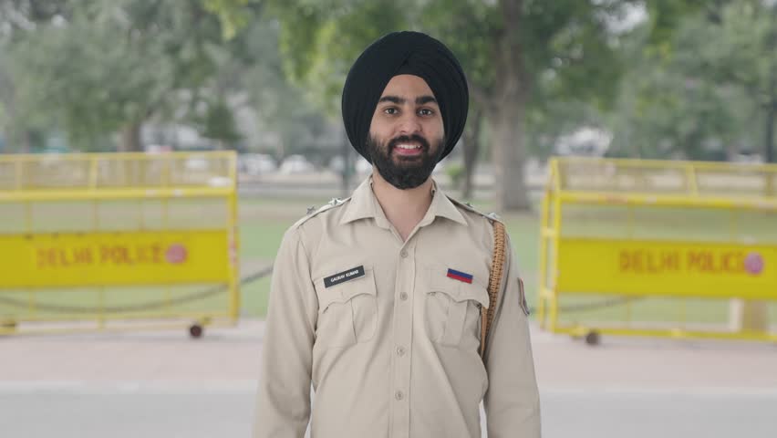 Happy Sikh Indian police man showing okay sign