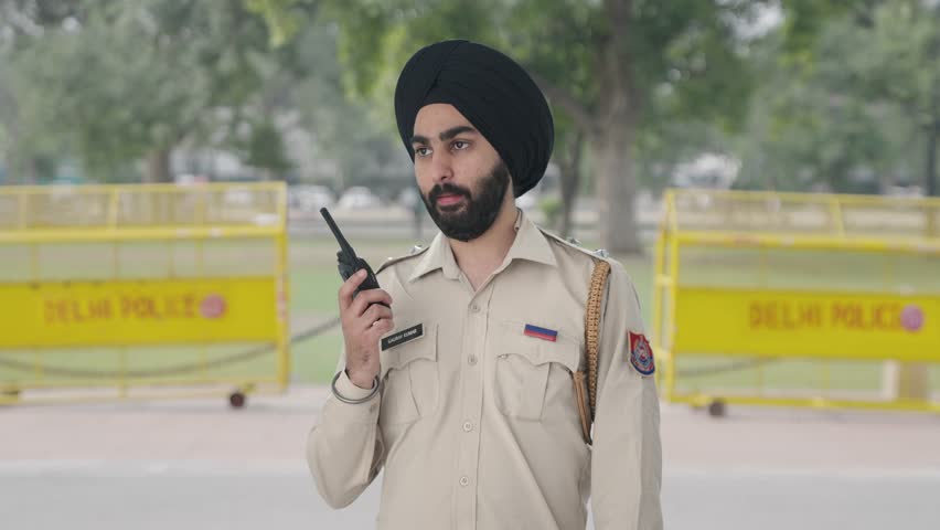 Angry Sikh Indian police man talking on radio