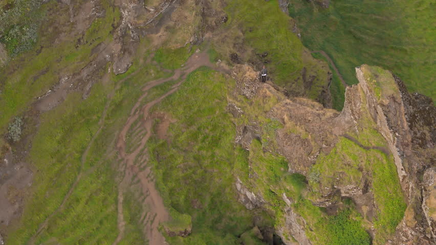 Breathtaking view of rocky mountains with great plains covered with green grass and narrow tourist tracks, photographic iconic nature of Iceland in summer. High quality 4k footage