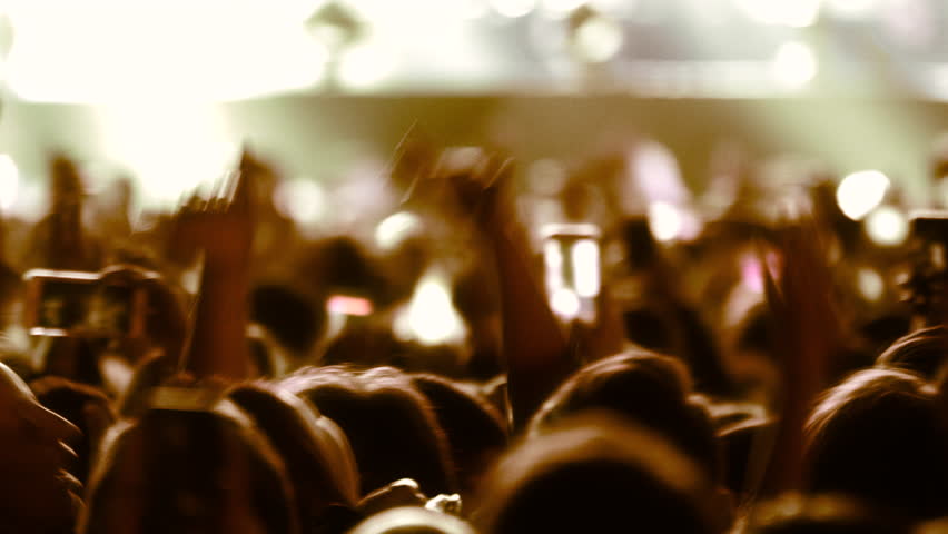 Crowded people in a night party concert view. Young celebrating guys dancing and clapping hands in joyfull concert taking photos and videos for social media sharing.  Royalty-Free Stock Footage #3409276623