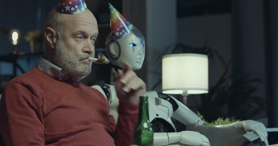 Lonely senior man sitting on the couch at home with his AI robot and having a party, he his drinking beer and blowing into a party horn