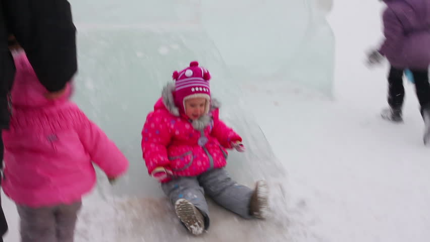 little girl on winter ice slide