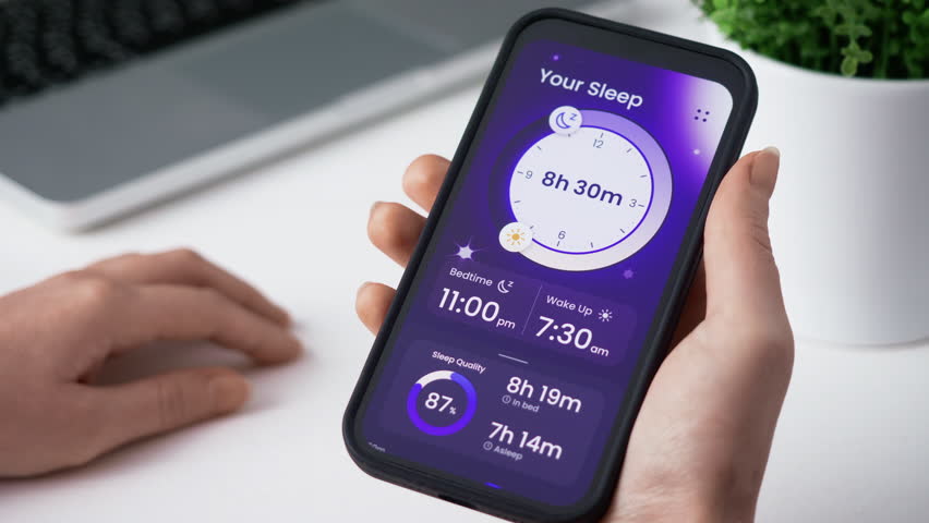 Monitoring sleep tracking information on a smartphone app Using the diagnosis app, analyze deep, light, and REM sleep data to determine its quality and quantity. Royalty-Free Stock Footage #3409405071