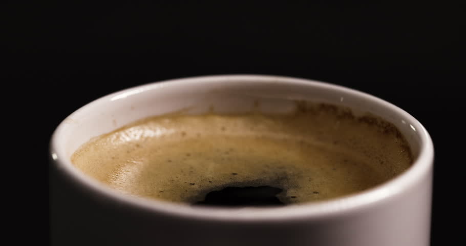 Graceful descent of a droplet into a coffee cup, captured in mesmerizing super slow motion