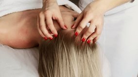 Beautician cosmetologist makes a relaxing head and hair massage professional procedure in a beauty clinic salon for client. Spa health and self-care concept. - Powered by Shutterstock - Get 15% off with code: PIKWIZARD15