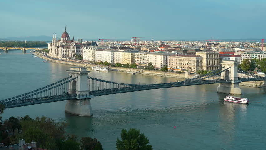 Tourist riverboat passes under the Széchenyi chain bridge on the Danube River in the Hungarian capital of Budapest.