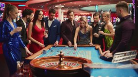 Casino Players Making Bets at a Roulette Table. Vibrant Crowd of International People Enjoying Nightlife in a City. Gamblers Excited About Successful Bets and Winning a Big Sum of Money. Slow Motion. - Powered by Shutterstock - Get 15% off with code: PIKWIZARD15
