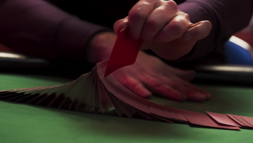 Close Up On Hands Of Professional Poker Dealer Ribbon Spreading Playing Cards Before High Stakes Game In Classy Casino. Anonymous Croupier Flipping Deck Before Competitive Tournament. Arc Shot.