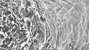 Pure beige water with reflections sunlight in slow motion. Water surface texture top view. Sun and shadows. Motion clean swimming pool ripples and wave. - Powered by Shutterstock - Get 15% off with code: PIKWIZARD15