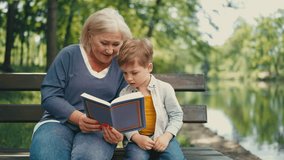 Loving granny reading book together with little grandson, enjoying family time - Powered by Shutterstock - Get 15% off with code: PIKWIZARD15