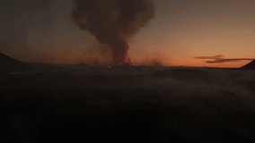 Dramatic smoke cloud over Fagradalsfjall volcano eruption site Iceland, low altitude aerial drone view at sunrise