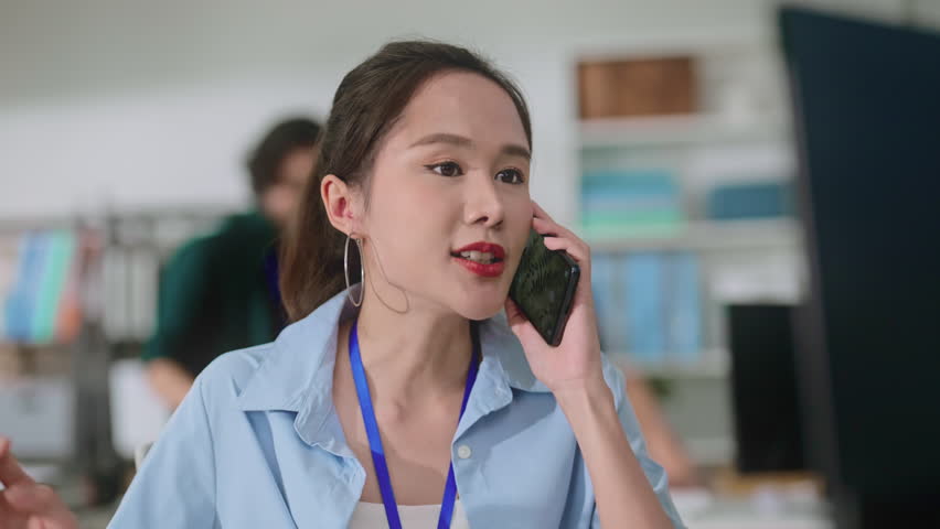 focused and dedicated work with asian female woman concentrating on her tasks in the office professionalism concentration and a productive work environment making it an ideal smartphone success work Royalty-Free Stock Footage #3409558045