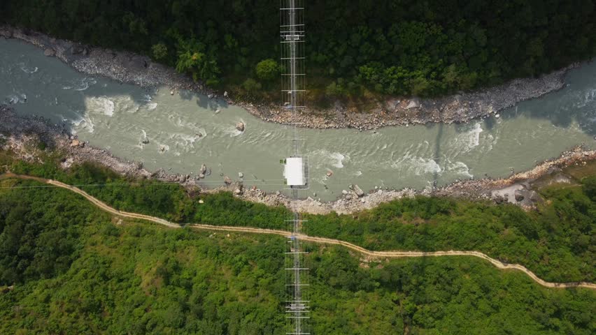 Aerial top down of jungle, flowing and bridge with bungee jumping in Nepal, Asia