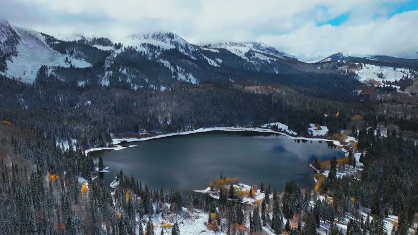 Upper lower Lost Lake Kebler Pass aerial cinematic drone Crested Butte Gunnison Colorado seasons collide early fall aspen tree red yellow orange forest winter first snow powder Rocky Mountains forward