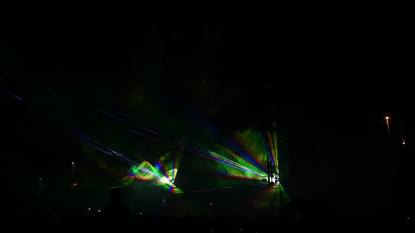 Laser lights and fog on the stage during concert. Multicolored light show at night. Abstract background. Laser beam.