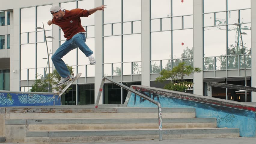 Young skater making 360 flip jump, performing kickflip trick, skateboarder training in skatepark, making tricks, slides and flips, professional extreme sport athlete training ride on skateboard. 
