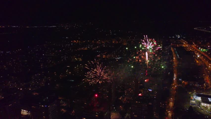 Colorful New Year fireworks over building in a city