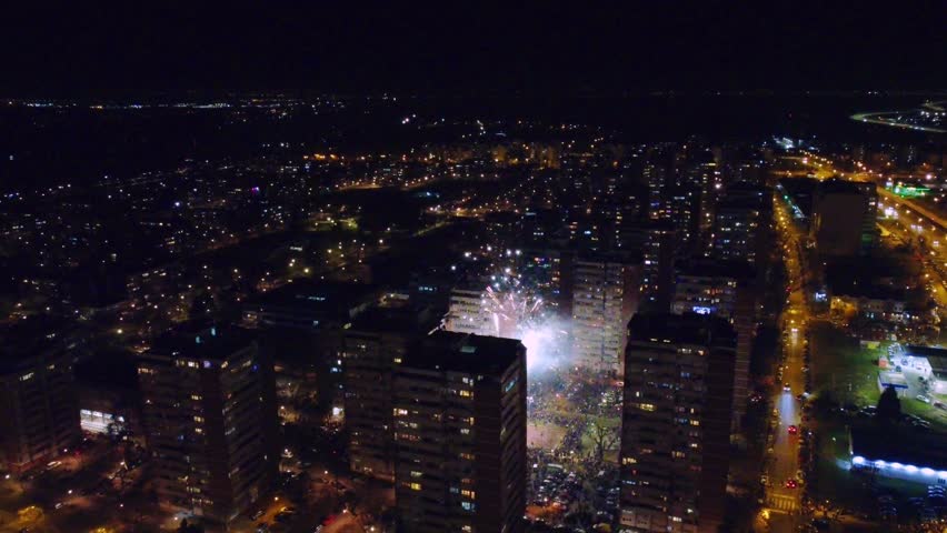 Colorful New Year fireworks over building in a city