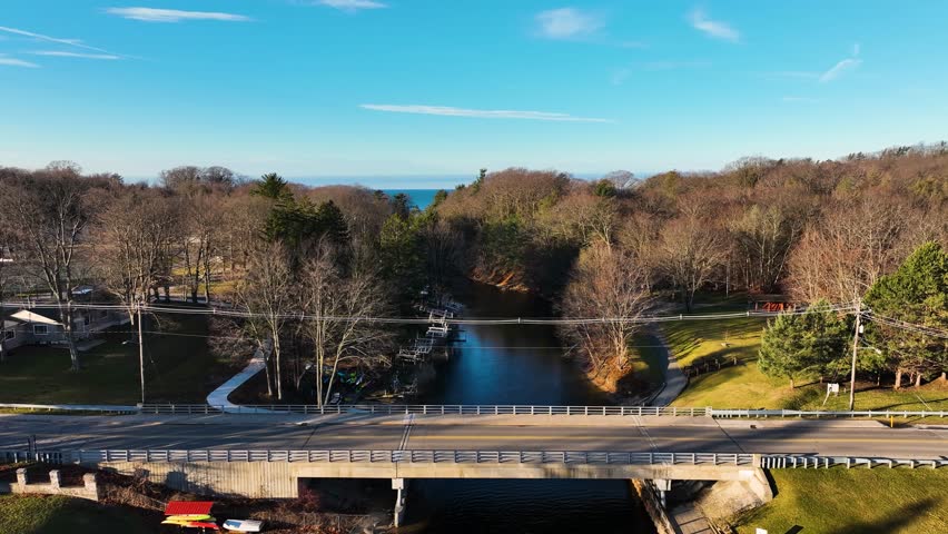 Facing the crisp waters of Lake Michigan from above a small bridge.