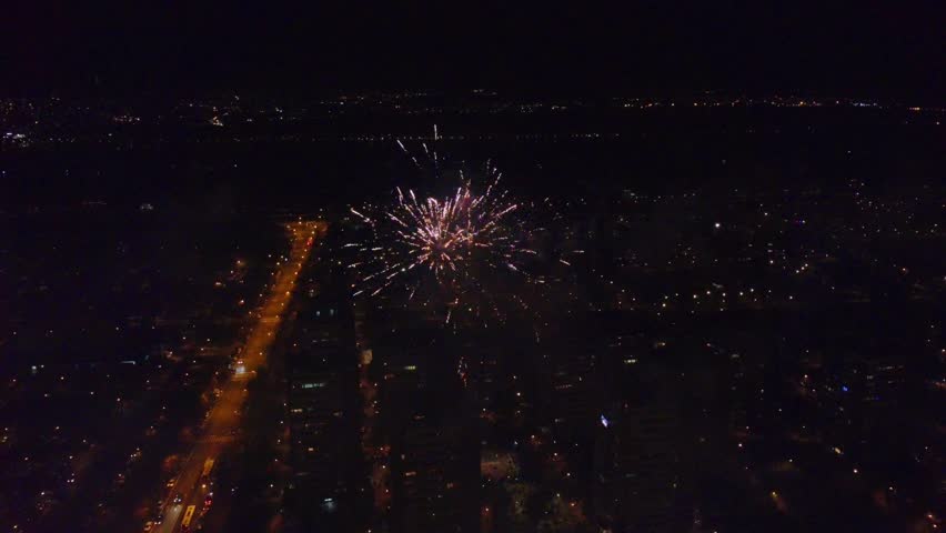 Colorful New Year fireworks over building in a city