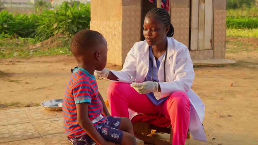 Slow motion black female african woman nurse doctor in white lab coat preparing syringe for giving a vaccination medical treatment to a black kid child in poor village of africa Royalty-Free Stock Footage #3409646535