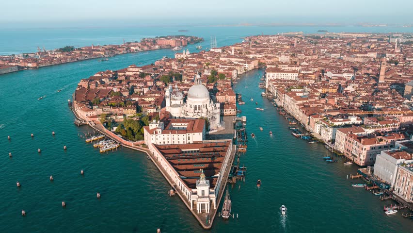 Aerial time lapse of morning golden hour in Venice, rotating around Saint Mary basilica giving a panoramic view of the city