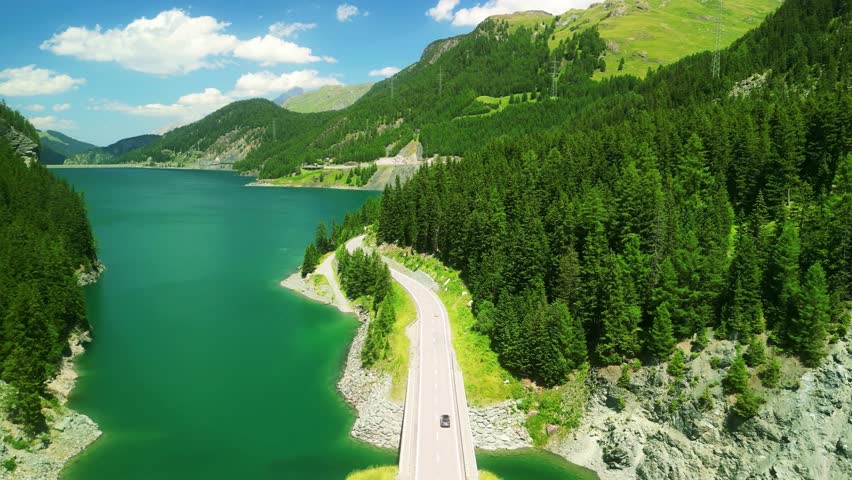 Aerial drone view of scenic drive to St. Moritz. scenic Bernina Pass in Swiss Alps. Switzerland summer tourism.