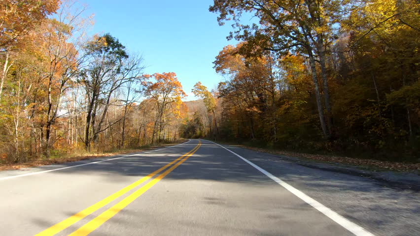 Point of view driving along a country road in West Virginia, surrounded by Autumn (Fall) foliage.