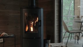 Cozy house chimney fire place in black color with fire burning in, tiny house, cabin house interior, wooden wall, backgrounds, slow motion. - Powered by Shutterstock - Get 15% off with code: PIKWIZARD15