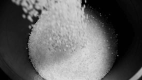 Filling the tank with plastic granules. The process of producing parts from polyethylene compound. White granules are poured into a container. - Powered by Shutterstock - Get 15% off with code: PIKWIZARD15