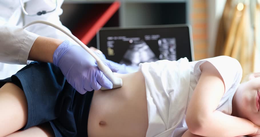 Medical examination of little girl using ultrasound equipment. Sonographer moves transducer on child abdomen and kidneys. Professional clinical diagnostics and treatment Royalty-Free Stock Footage #3410103099