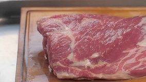 Man chef cooking beef steak angus close-up. Professional cheif preparing meat in restaurant kitchen. 
