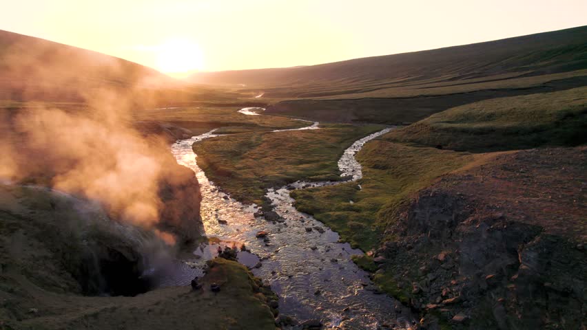Steam Rising From Laugavellir Natural Pool at Sunrise. Aerial High Angle View of Hot Spring River Natural Landscape in Iceland.